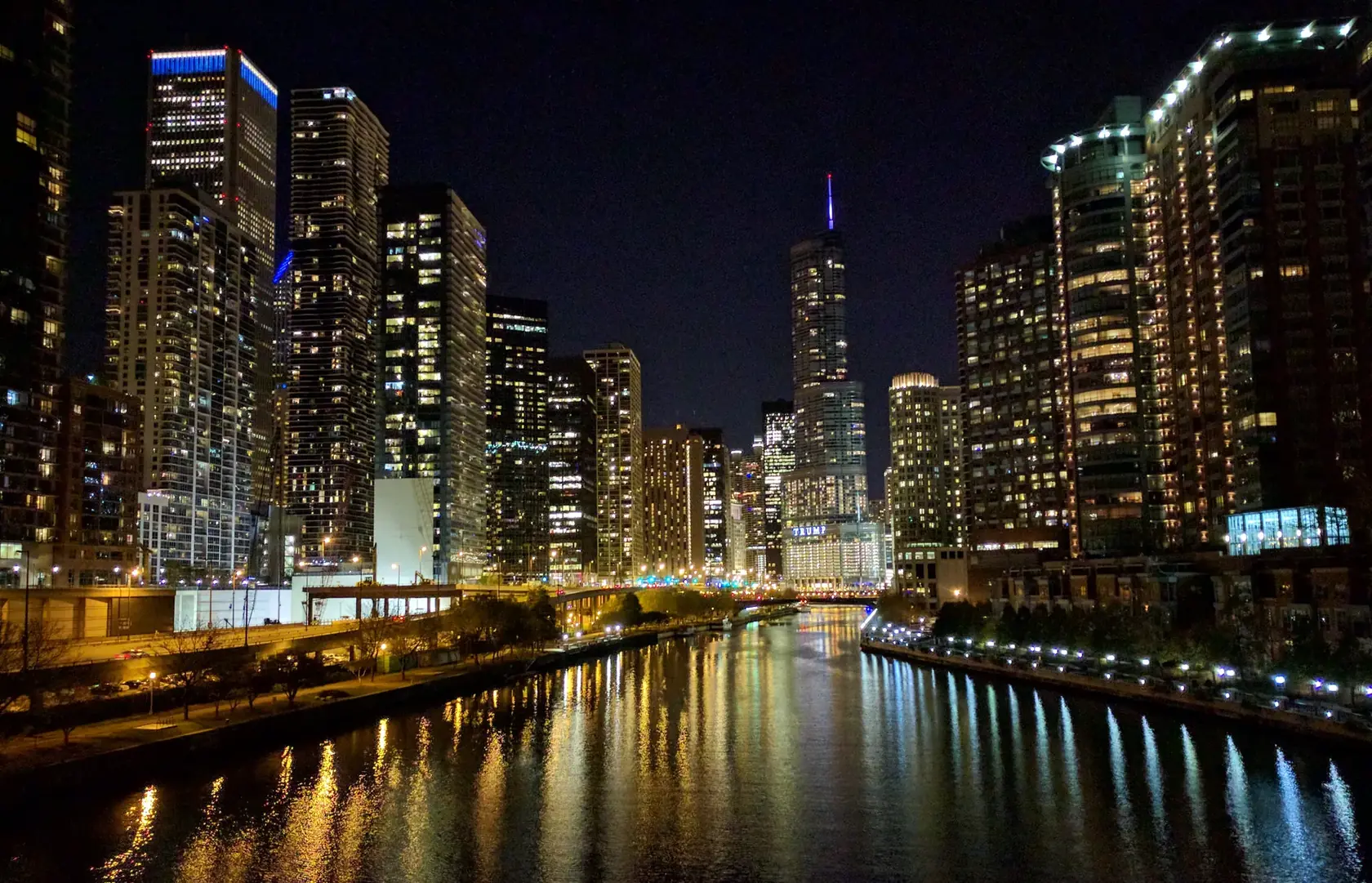 The Chicago River at night, lined with lit towers, looking east toward the lake.